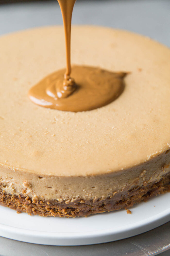 pour melted cookie butter spread over biscoff cheesecake.
