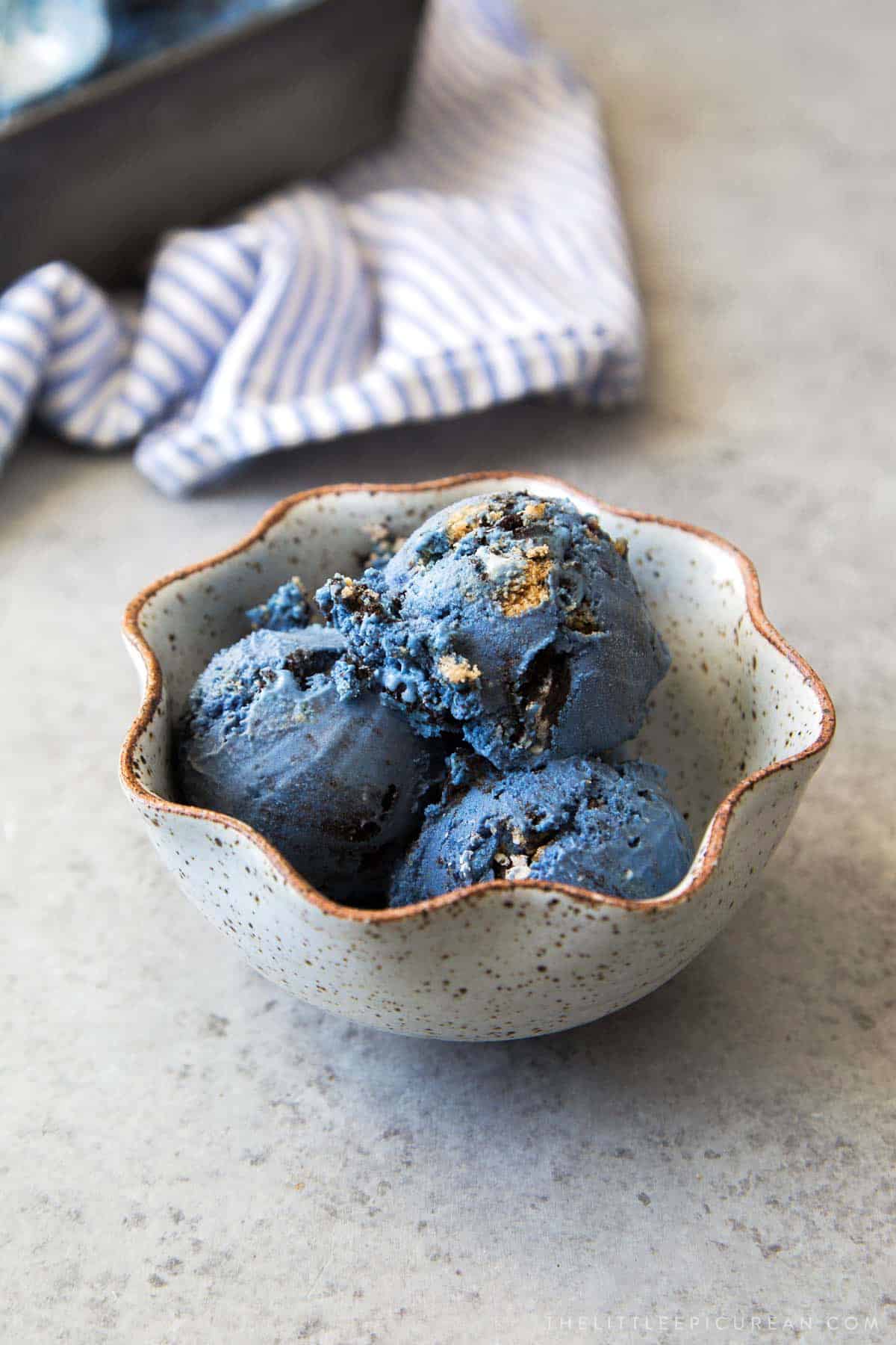 scoops of cookie monster ice cream in fluted bowl.