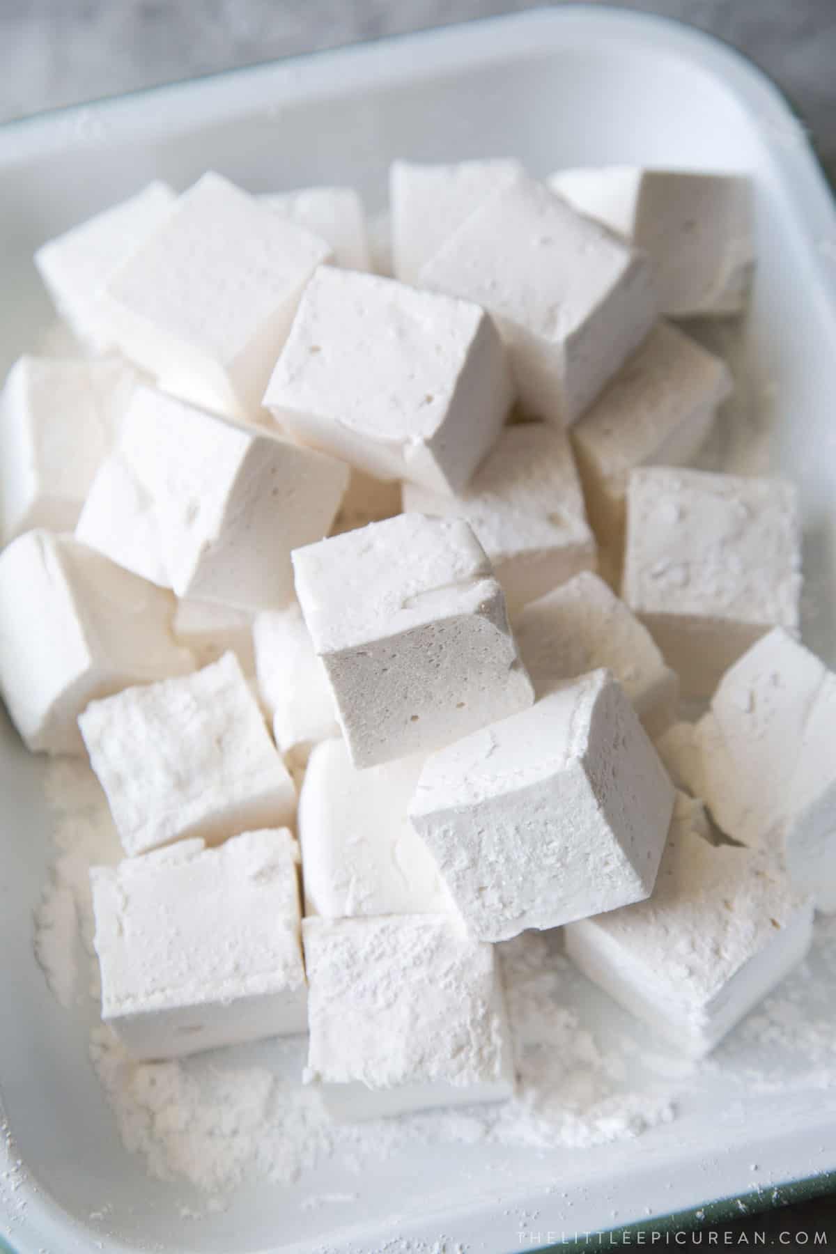 homemade marshmallow squares in a serving platter.