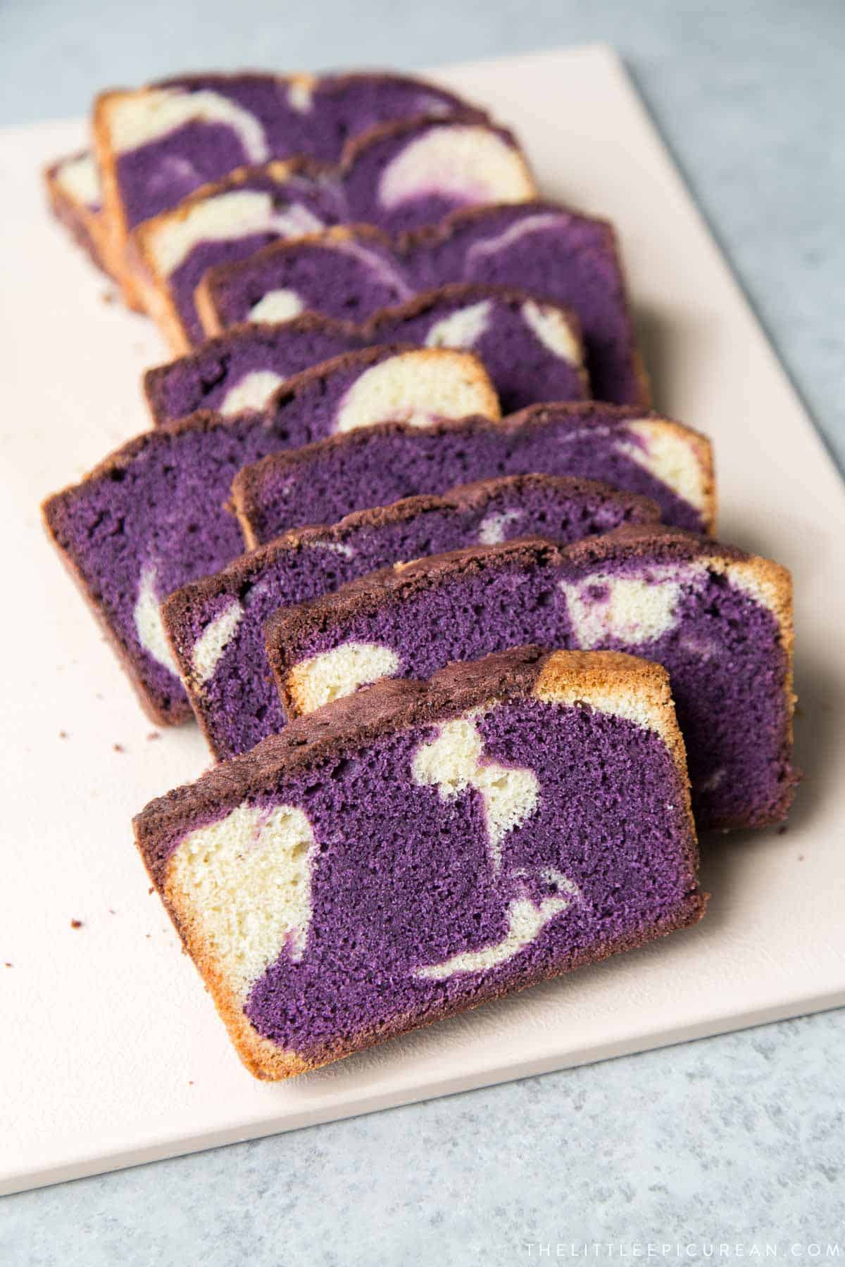 mable ube pound cake slices on cutting board.