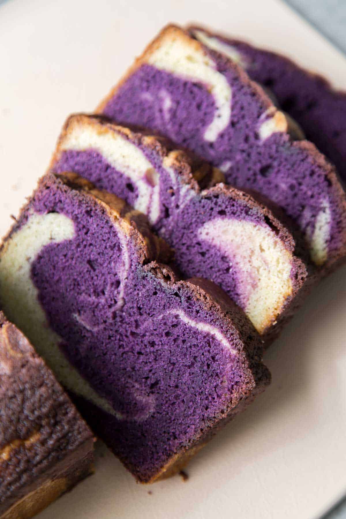 slices of marble ube pound cake on cutting board.