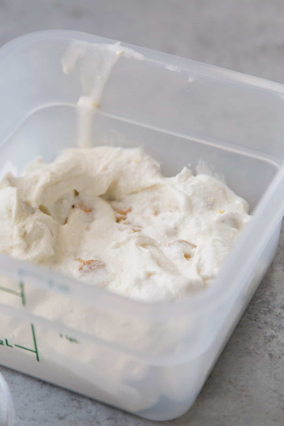 add a layer of cheesecake ice cream to freezer safe container.