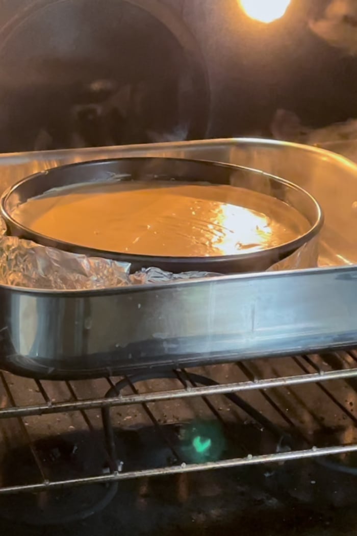 cool cheesecake in pan in oven.