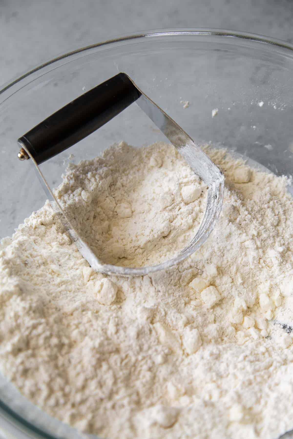 cut cold butter into flour mixture using a pastry blender.