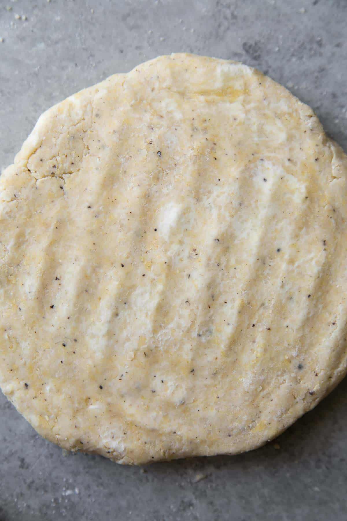 pockets of butter peaking through savory scone dough.