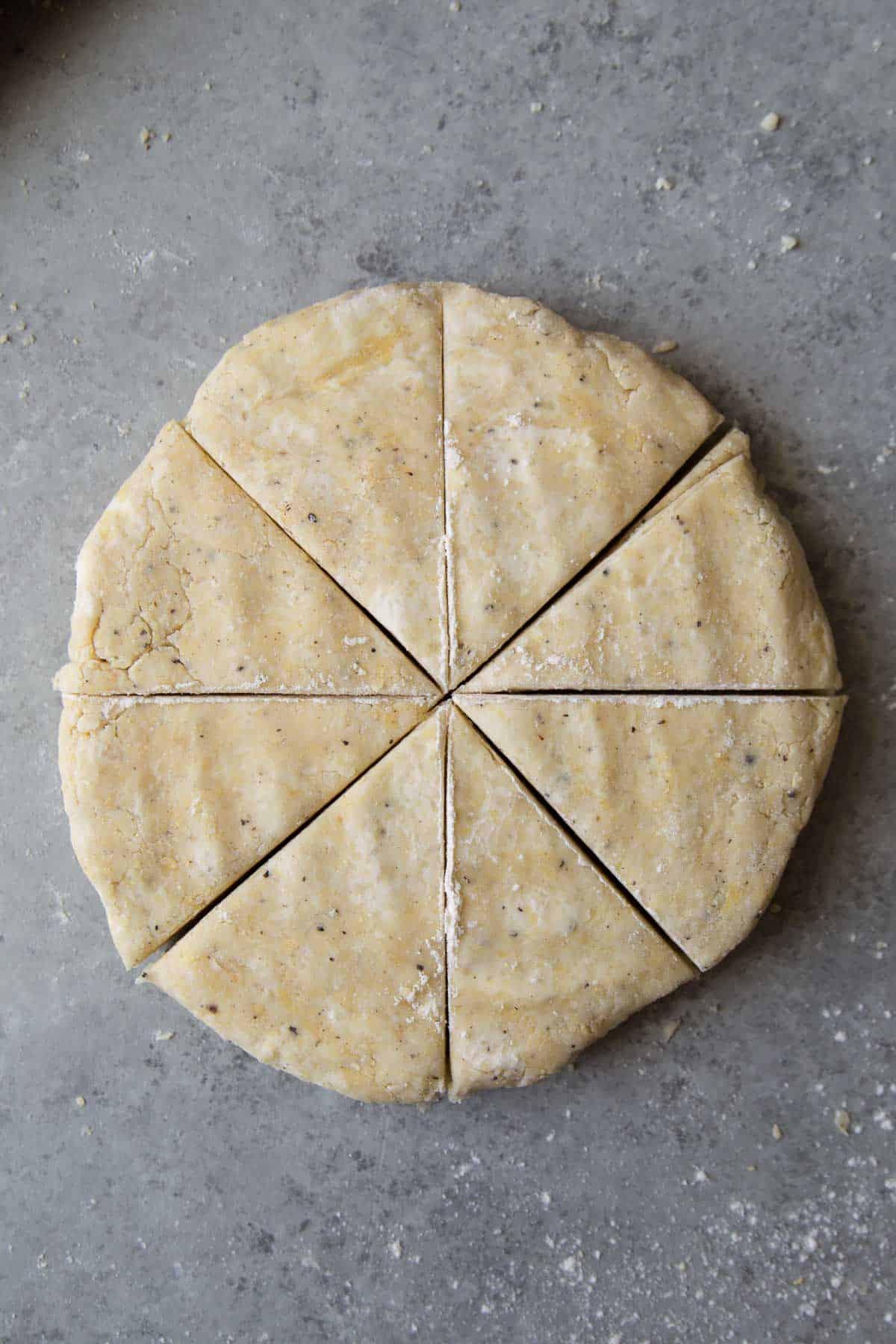 cut savory cheese scone dough into 8 equal sized wedges.