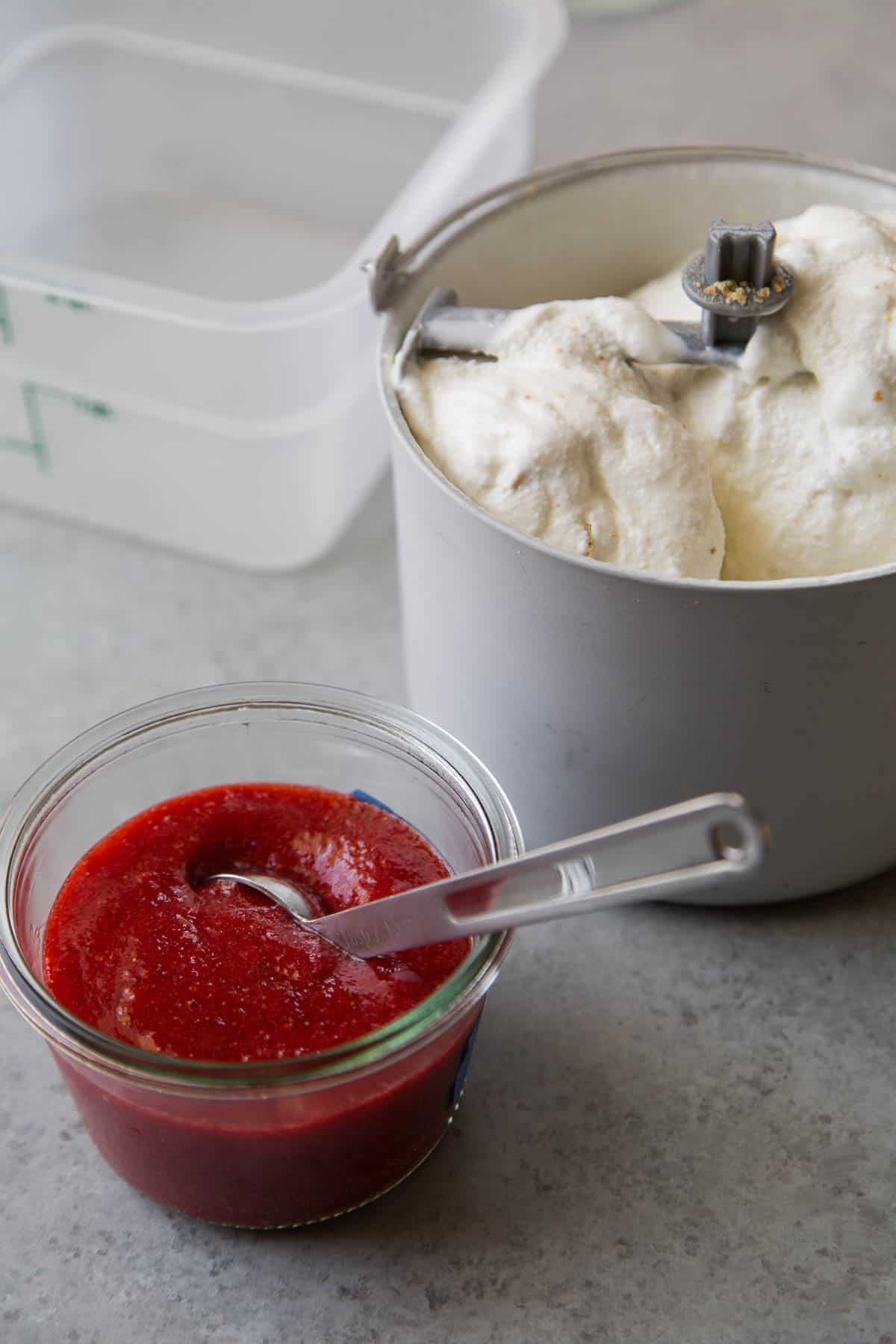 alternate adding layers of strawberry sauce and cheesecake ice cream in freezer safe container.
