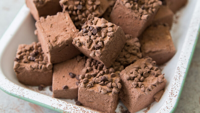 chocolate chip chocolate marshmallows in a white enamel serving tray.