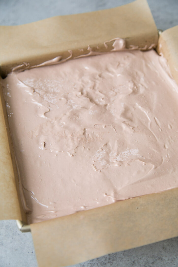 spread chocolate meringue into a smooth even layer.