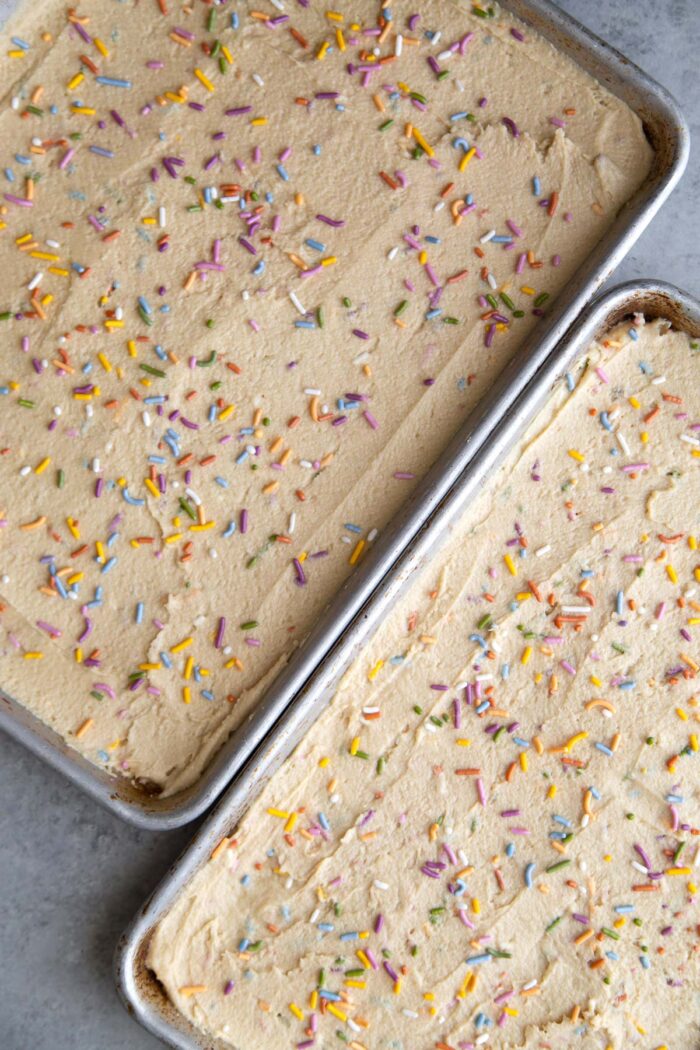 spread confetti sugar cookie dough on two sheet trays.