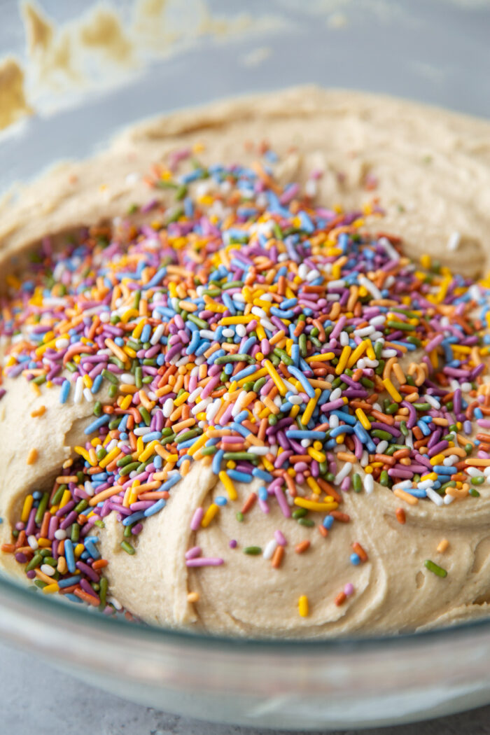 rainbow confetti over sugar cookie dough.