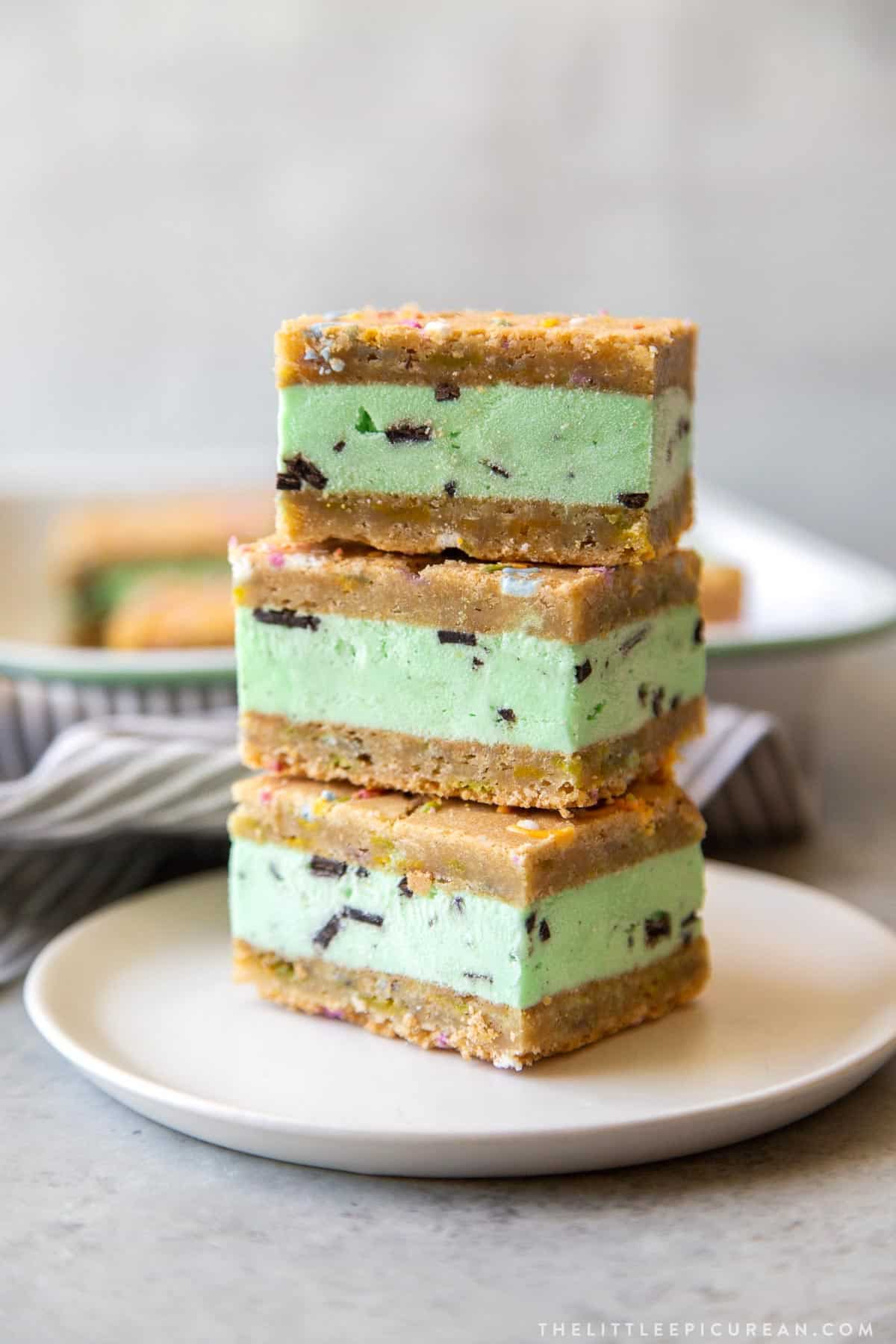 stack of three sprinkle cookie mint chocolate chip ice cream sandwiches.