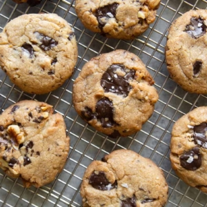 vegan chocolate chip cookies with walnuts cooling on wire rack.
