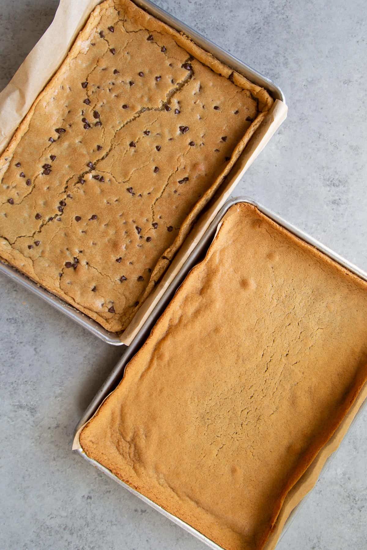 side by side quarter sheet pans of baked cookie dough.
