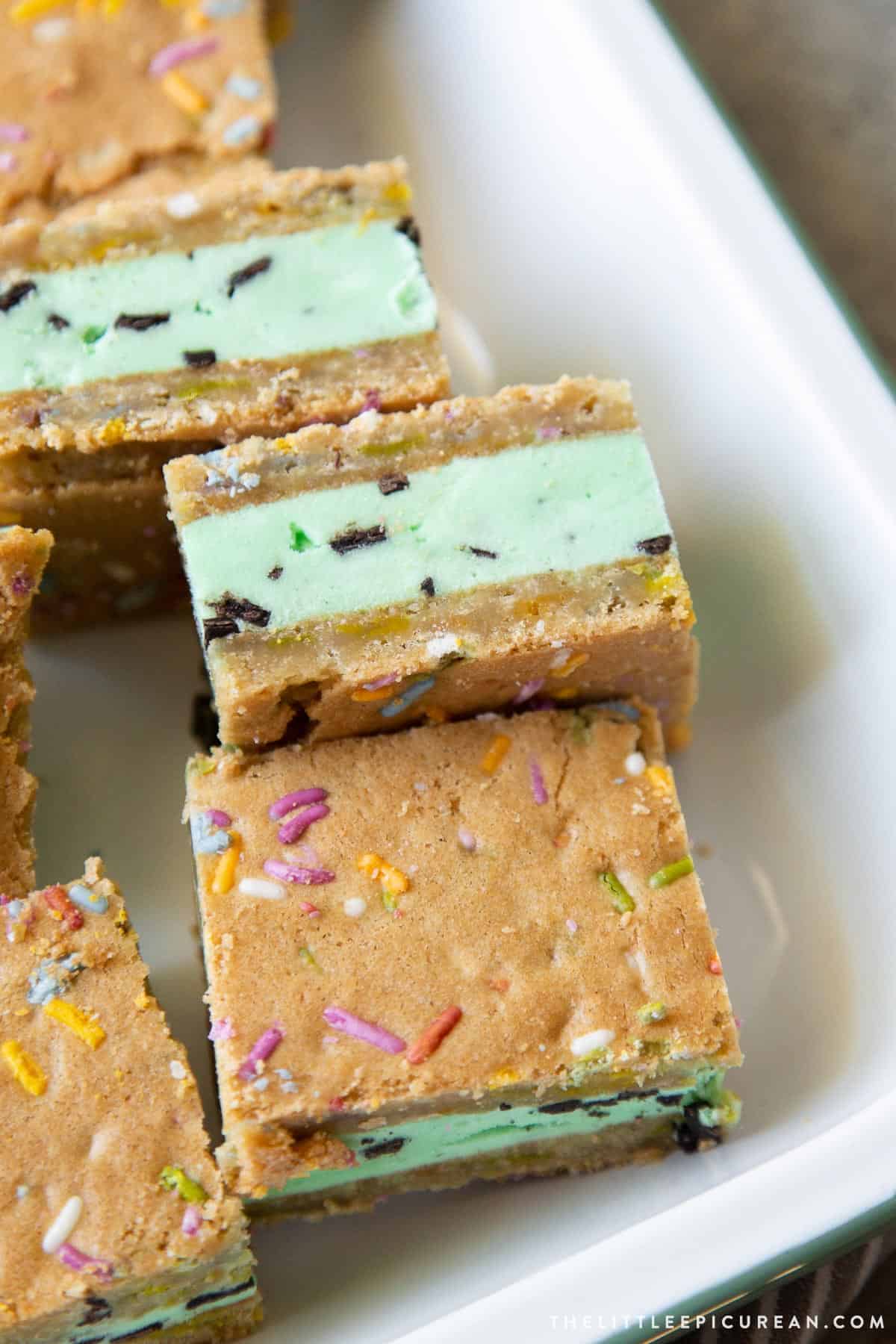 mint chocolate chip ice cream sugar cookie sandwiches on serving plate.