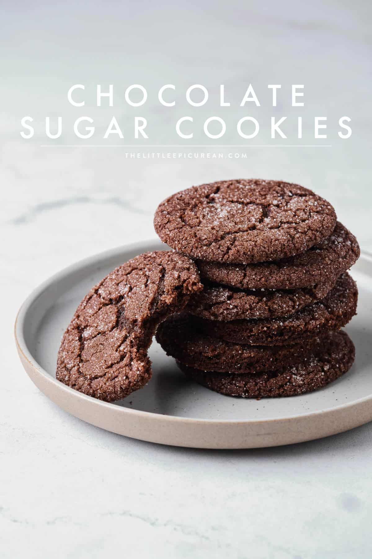 chocolate sugar cookies stacked on serving plate.