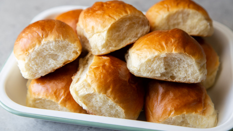 milk bread rolls piled up on serving platter.