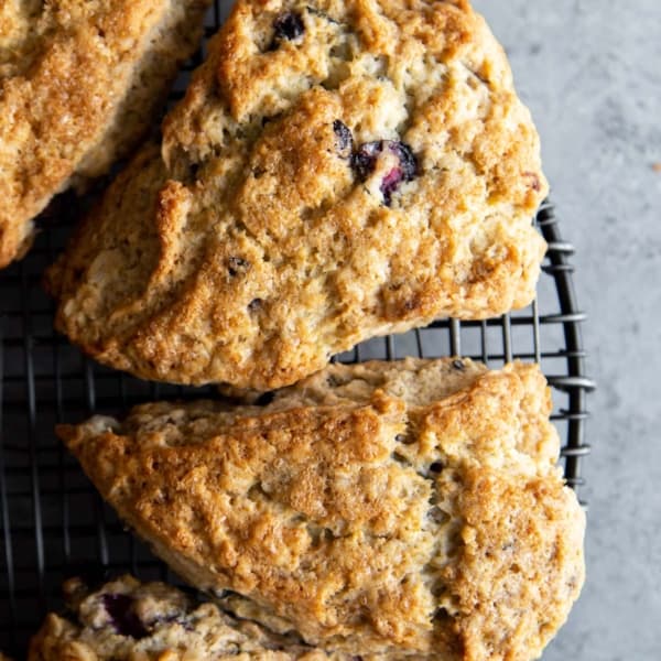 lemon blueberry oat scone wedges on wire cooling rack.