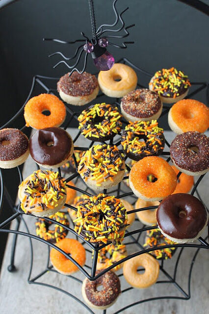 decorated mini halloween donuts on spider cake stand.