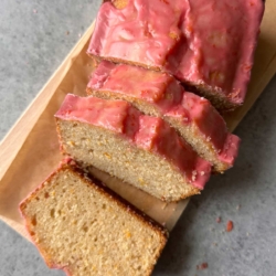 blood orange pound cake with blood orange glaze on cutting board.