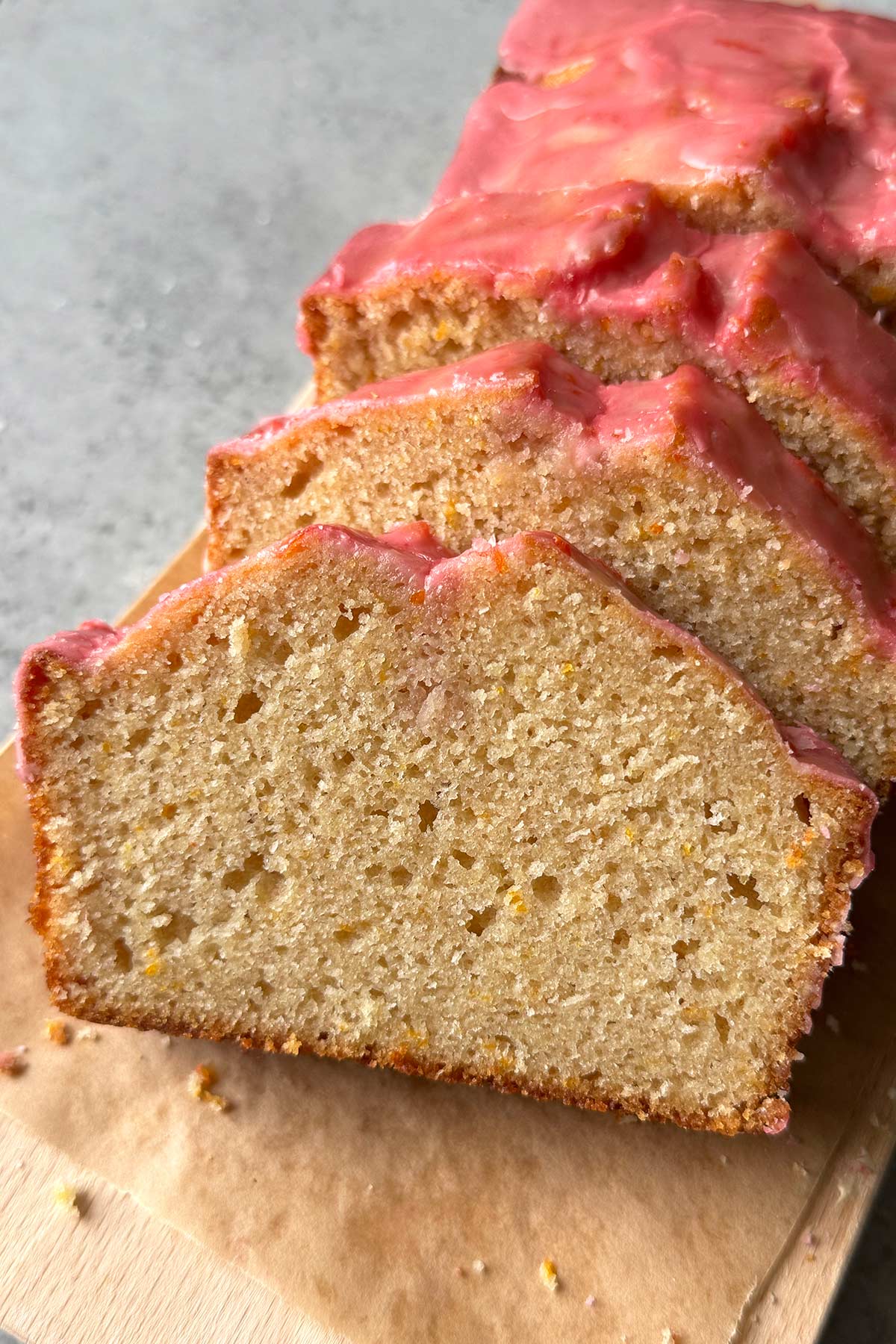 close up of blood orange pound cake slices show flecks of orange zest.