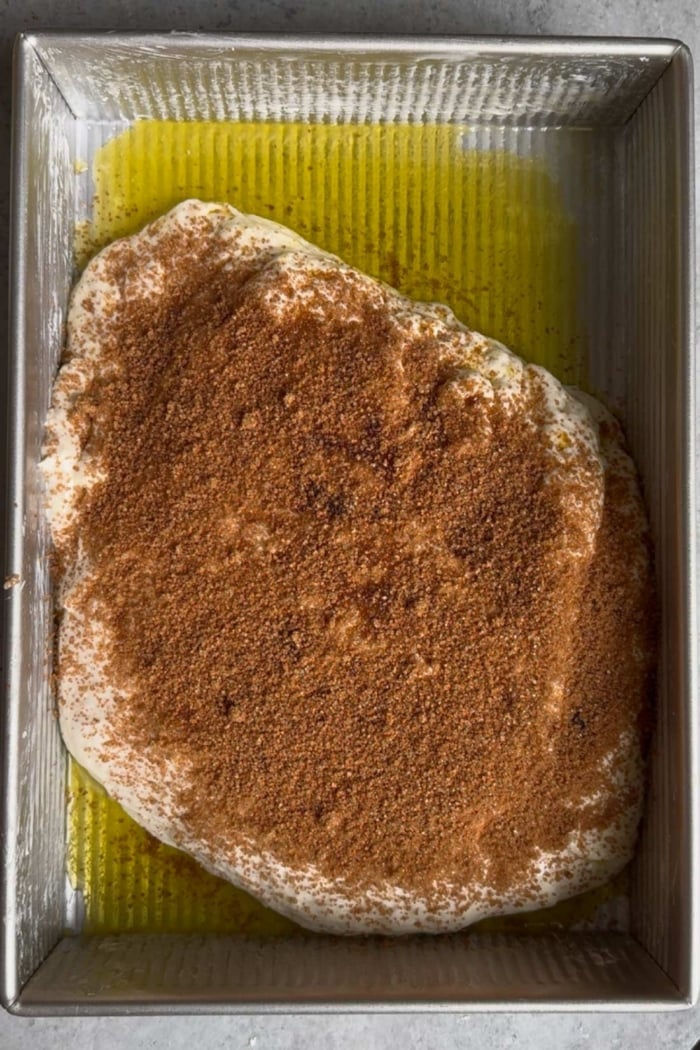 cinnamon sugar dusted on top of dough. 