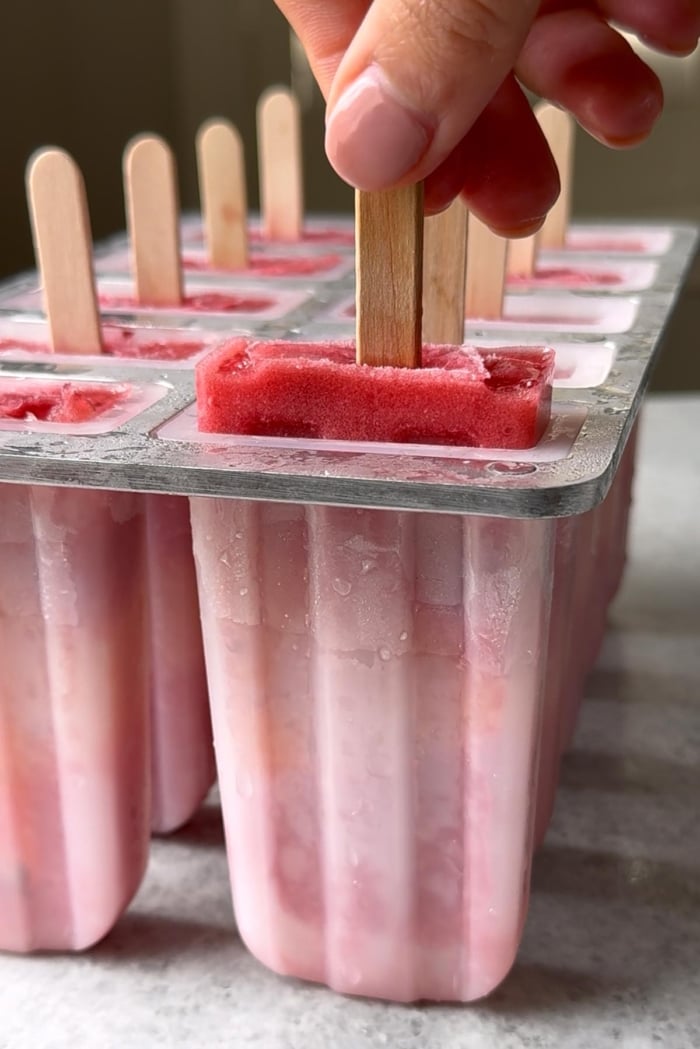 pull frozen popsicle from mold.
