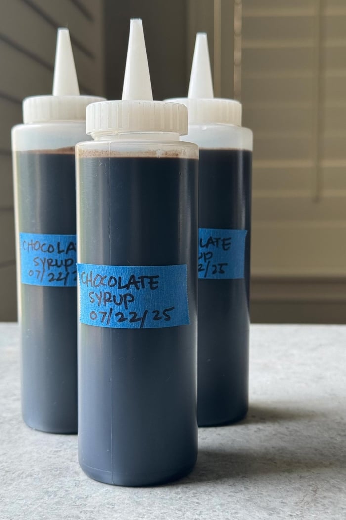 three bottles of homemade dark chocolate syrup.