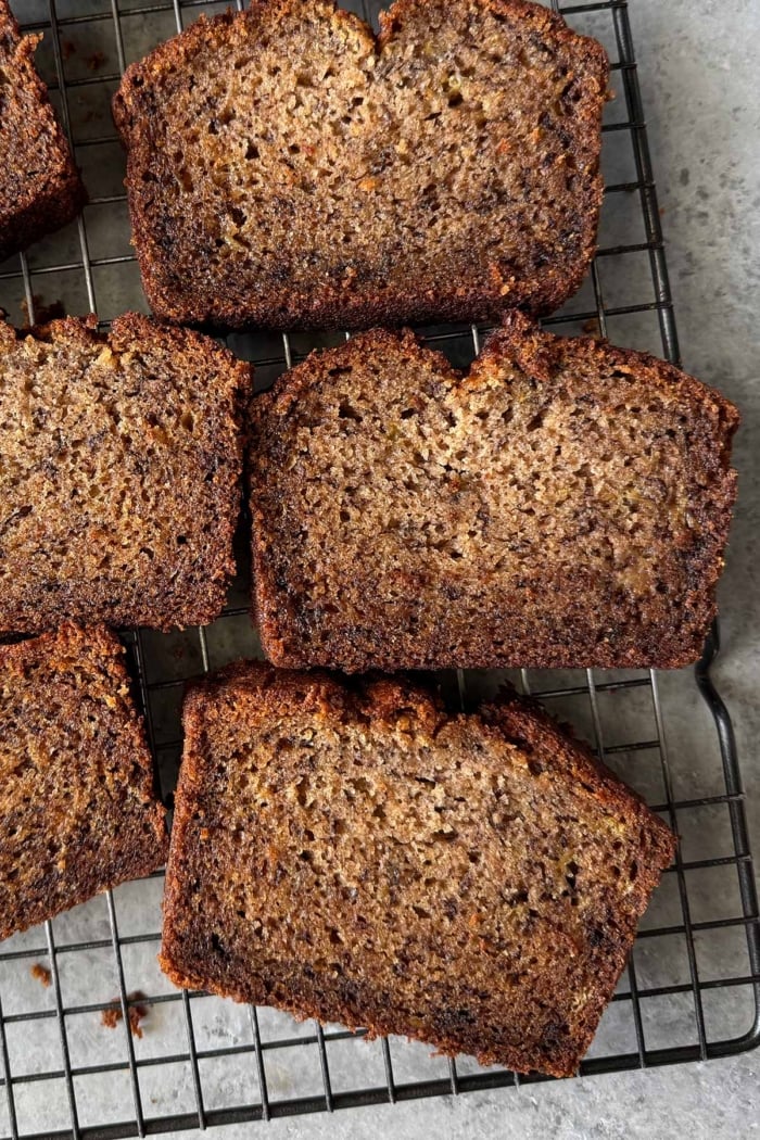 mochi banana bread slices on wire rack.
