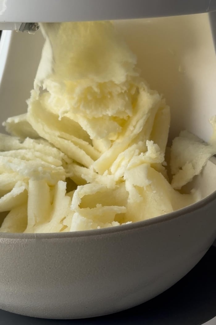 ribbons of frozen milk shaved in electric shave ice machine.
