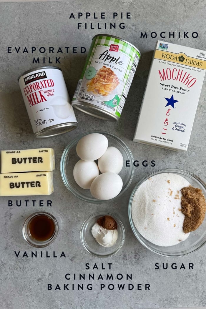portioned out ingredients for apple mochi cake laid out on gray table.