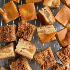 two versions of apple pie mochi butter cake on wire rack.
