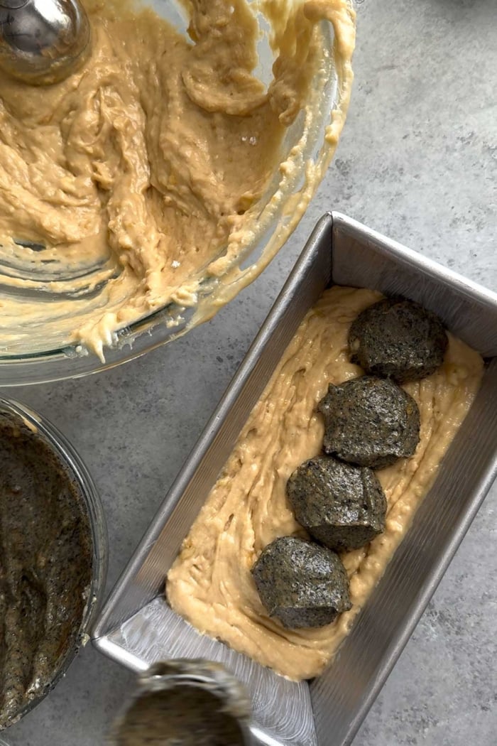 alternate adding layers of banana batter and black sesame batter to loaf pan.