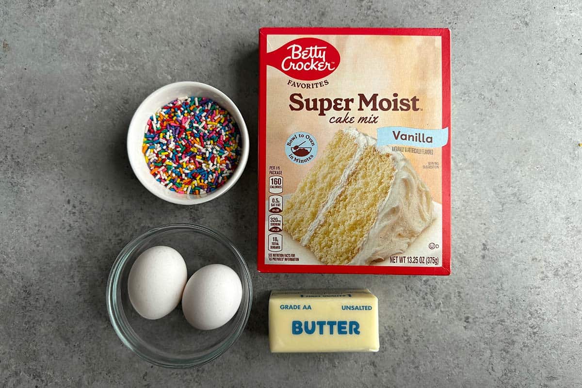 rainbow sprinkles, white cake mix, two eggs, and stick of butter.