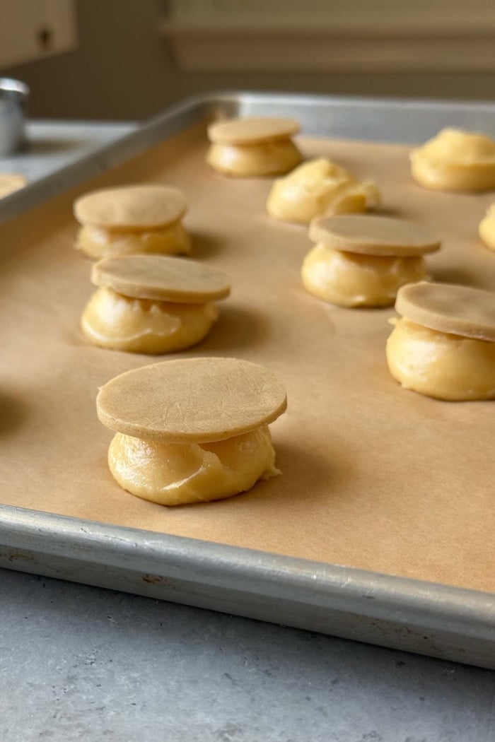 top pate a choux dough with cookie dough.