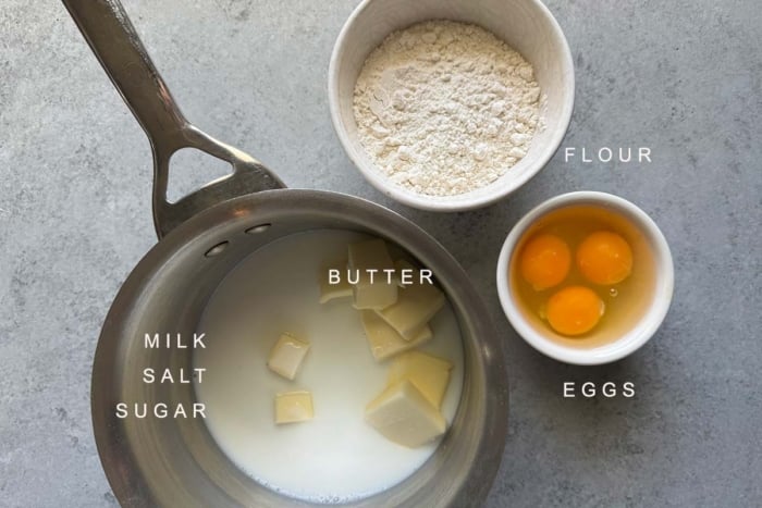 portioned out ingredients include milk, butter, flour and eggs.