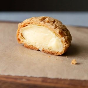 cross section of pastry cream filled choux au craquelin.