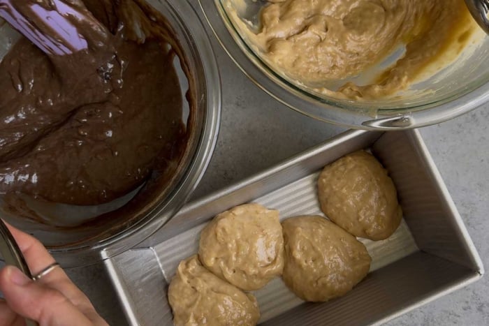 use cookie scoop to distribute two batters into loaf pan.