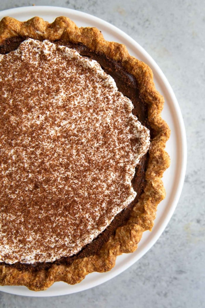close up overhead assembled banana cream pie filled with chocolate pastry cream.