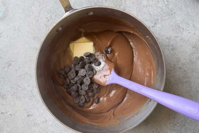 add chocolate chips, butter, and salt to hot pastry cream mixture in pot.