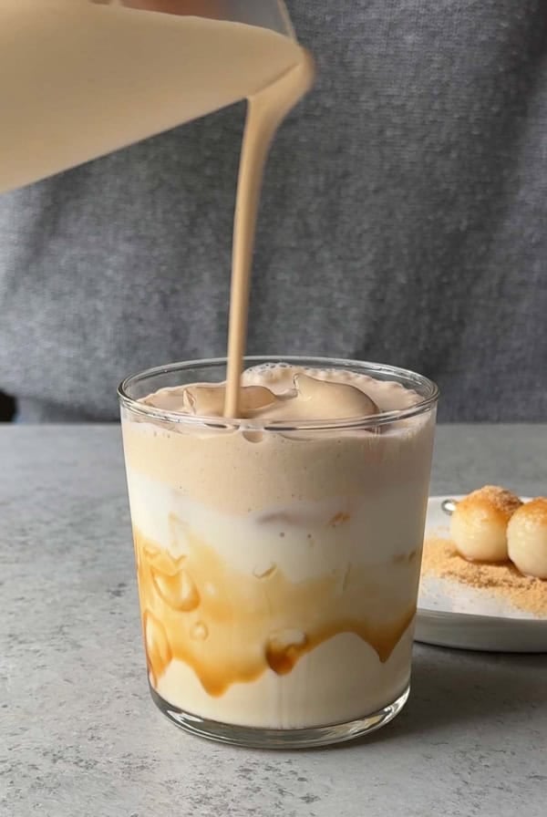 pour kinako cream top over assembled drink.