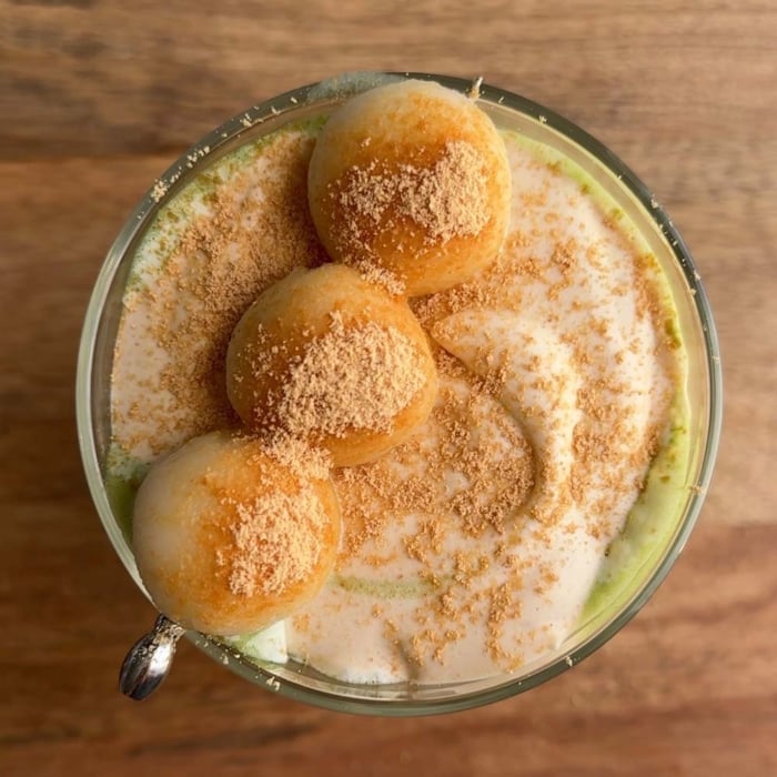 overhead of kinako matcha latte garnished with dango.