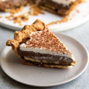 slice of banana chocolate cream pie on grey serving plate.