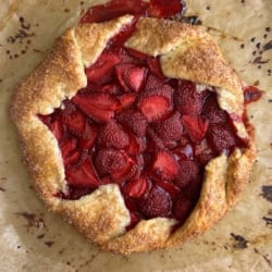 baked strawberry galette on parchment paper.