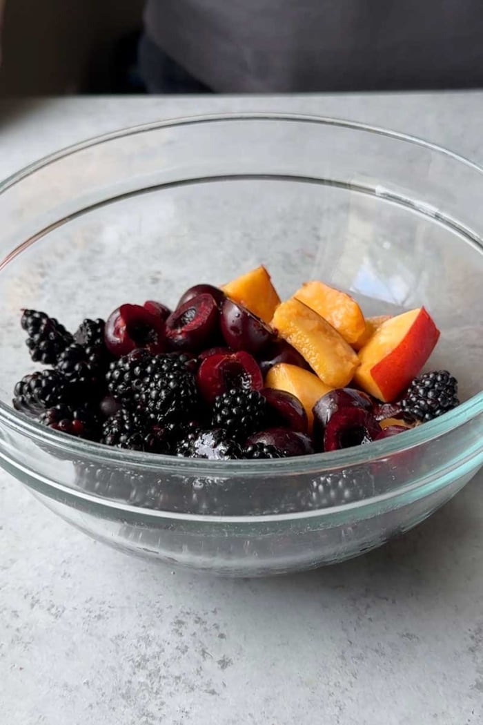 bowl of blackberries, cherries, and nectarine ready for pie or galette.