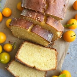 slices of glazed calamansi pound cake surrounded by fresh calamansi fruit.