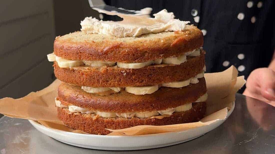 spread brown butter frosting over top layer of cake.