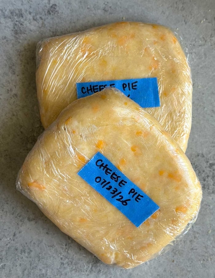 two wrapped portions of cheddar pie dough dated and labeled.