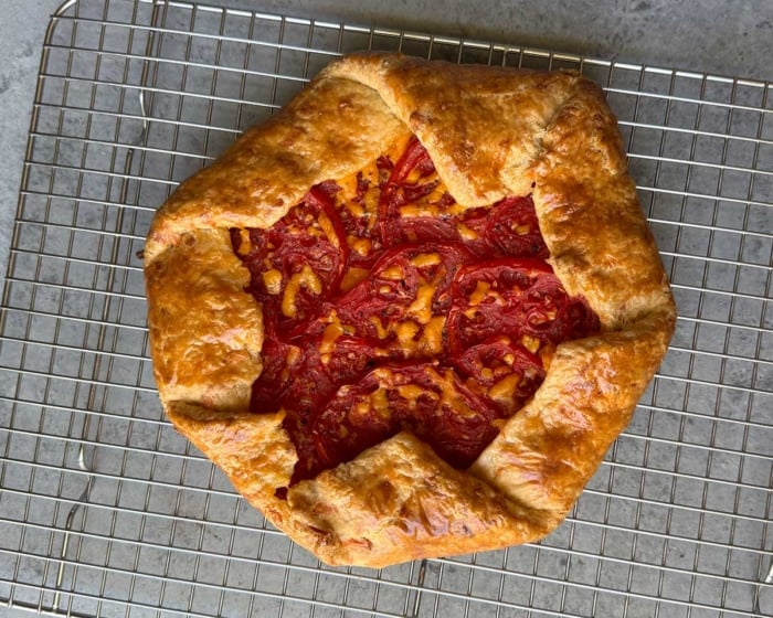 fresh baked cheddar tomato galette on wire rack.