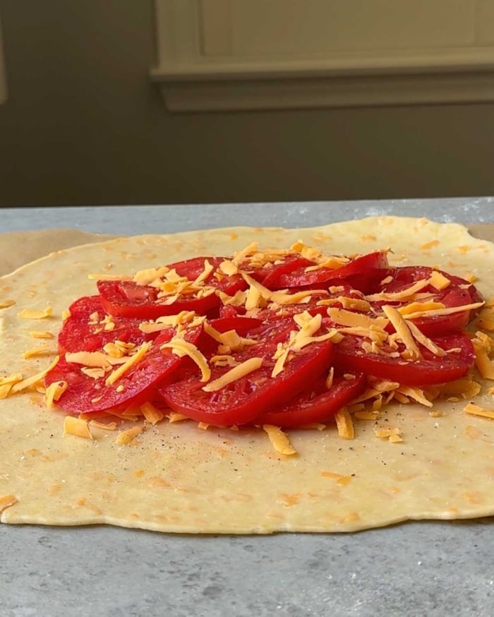 season tomatoes with additional cheese, salt, and pepper.